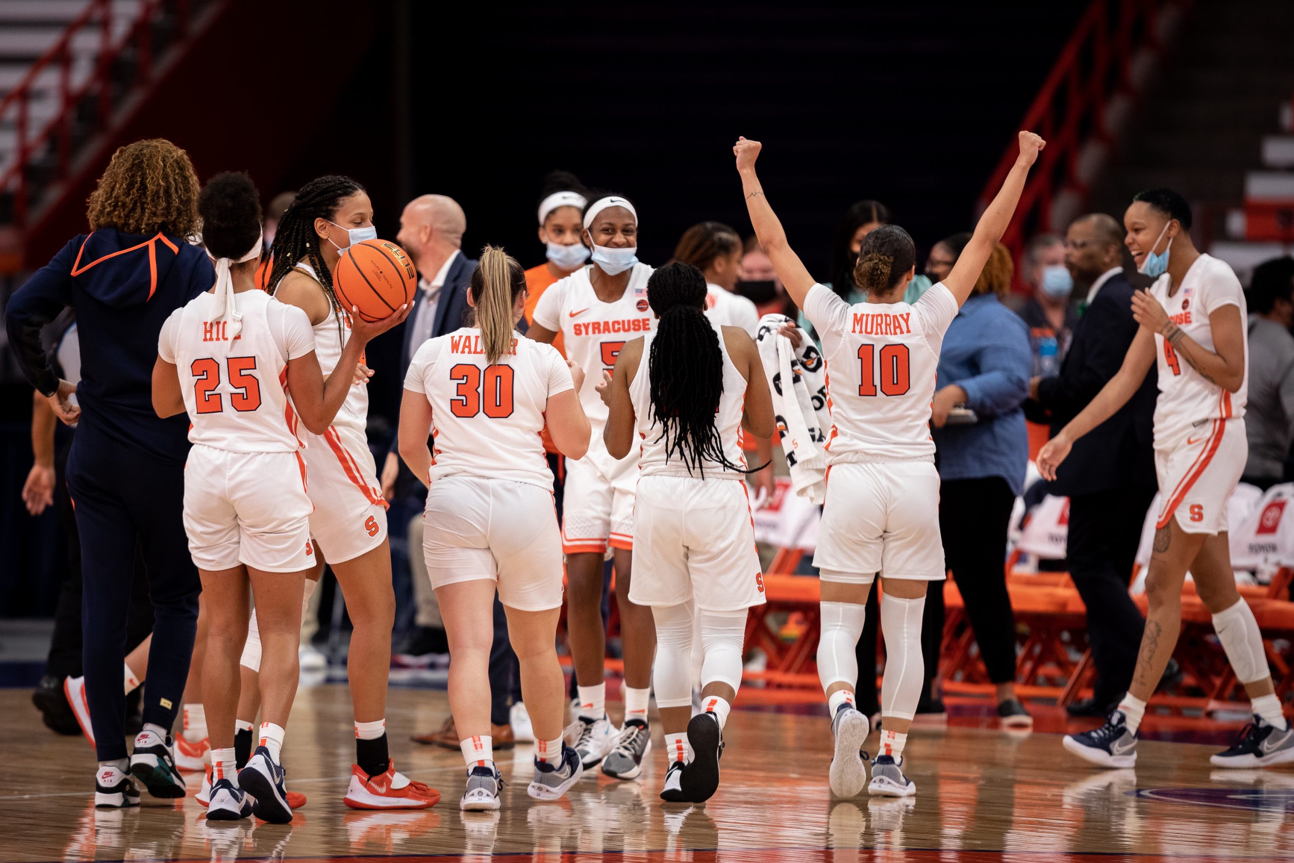 Najé Murray (10) raises her hands around here team after the final buzzer on Saturday in SU's win versus UMBC.