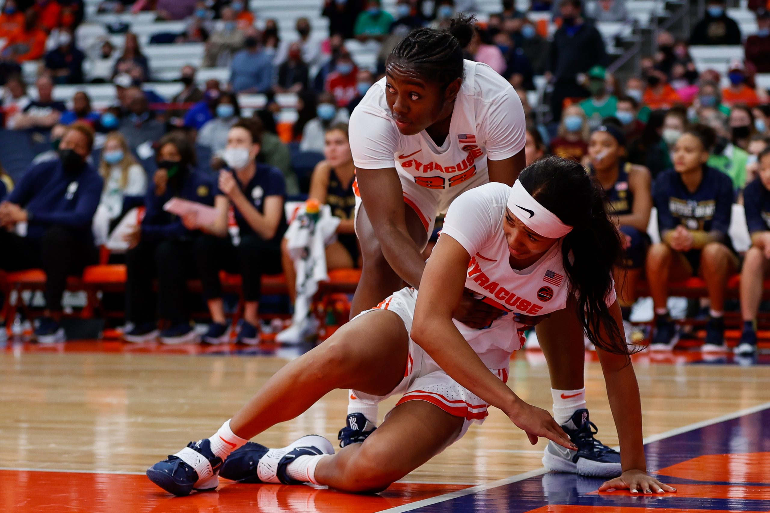 Syracuse's Eboni Walker helps up Alaina Rice during a Women's Basketball game against Notre Dame at the Carrier Dome on November 14, 2021.