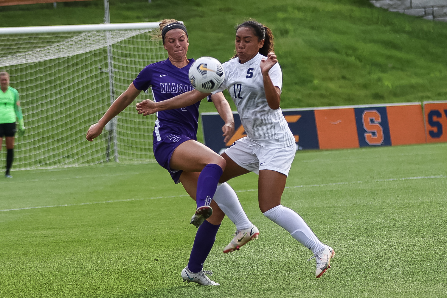 Syracuse’s Telly Vunipola (12) and Niagra’s Molly Tobin (5) brace for impact as the two battle for possession during an NCAA women’s soccer game, Thursday, at Syracuse Soccer Stadium. Niagara defeated Syracuse, 4-2.