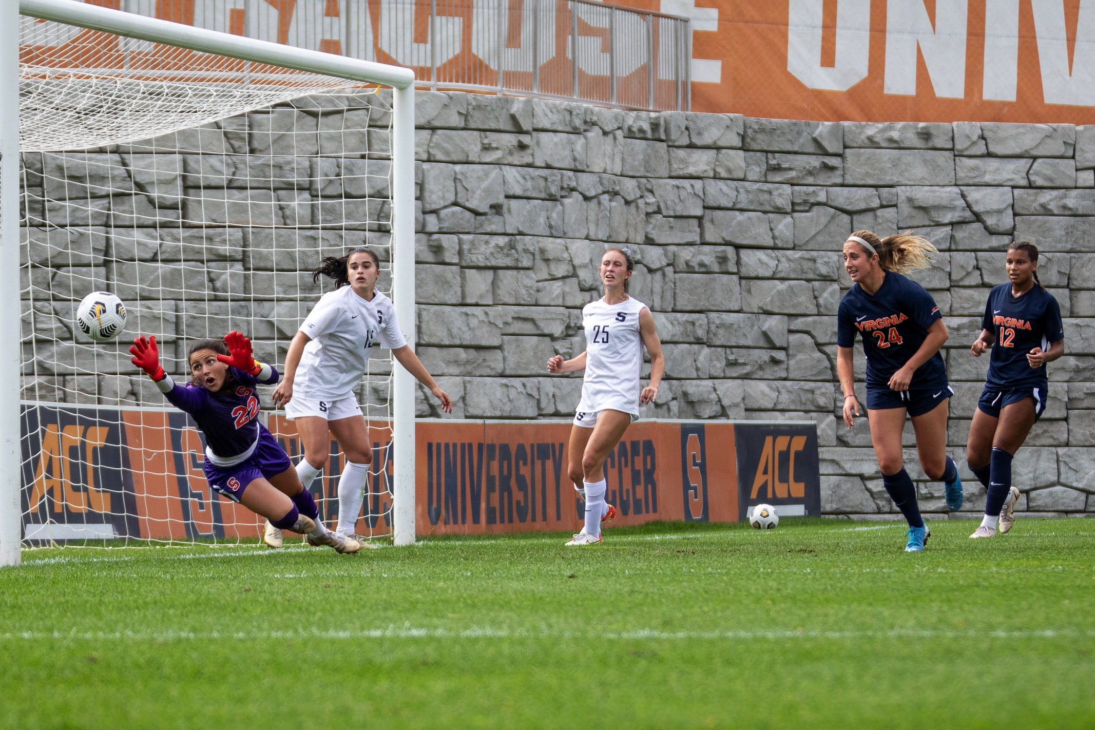 The ball flies past Syracuse's net-minder, Lysianne Proulx, for one of Virginia's five goals in the emphatic win over Syracuse on Sunday, October 10th, 2021..