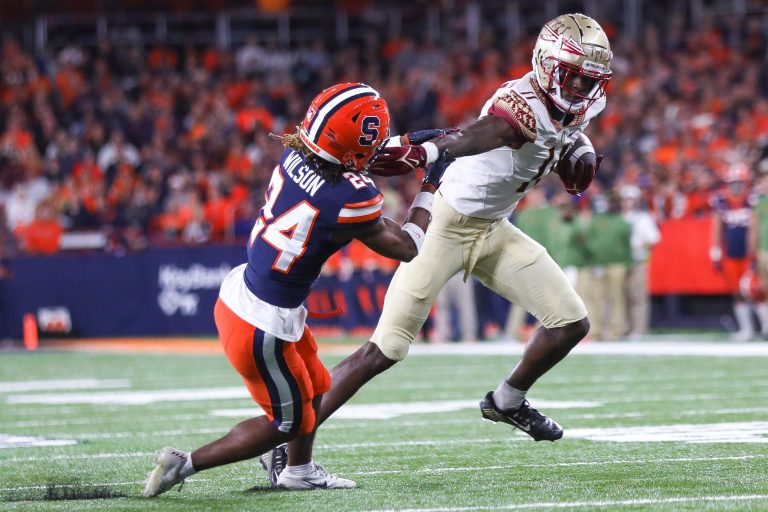 Orange defensive back Jeremiah Wilson gets stiffed armed by a Florida State player on November 12, 2022.