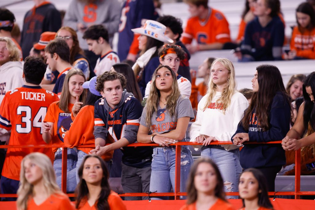 Syracuse University students look disappointed as the Orange continued to fall behind on the scoreboard.