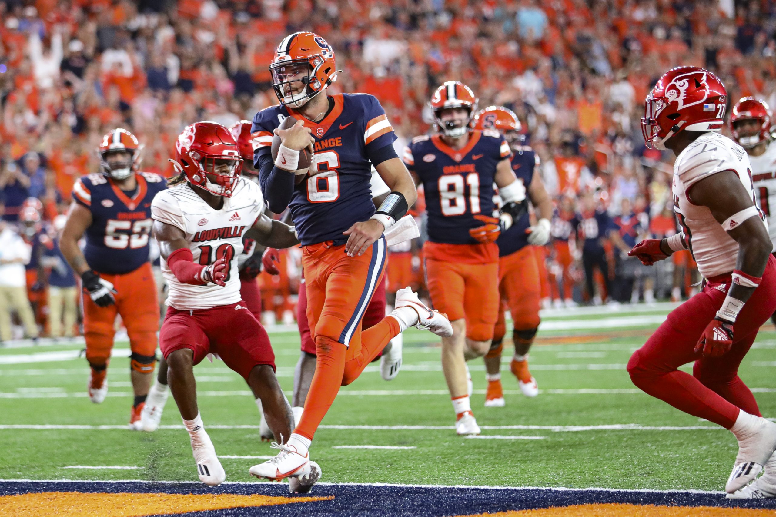 Syracuse quarterback Garrett Shrader coasts into the end zone as he splits Louisville defenders during an ACC football game on Saturday at JMA Wireless Dome.