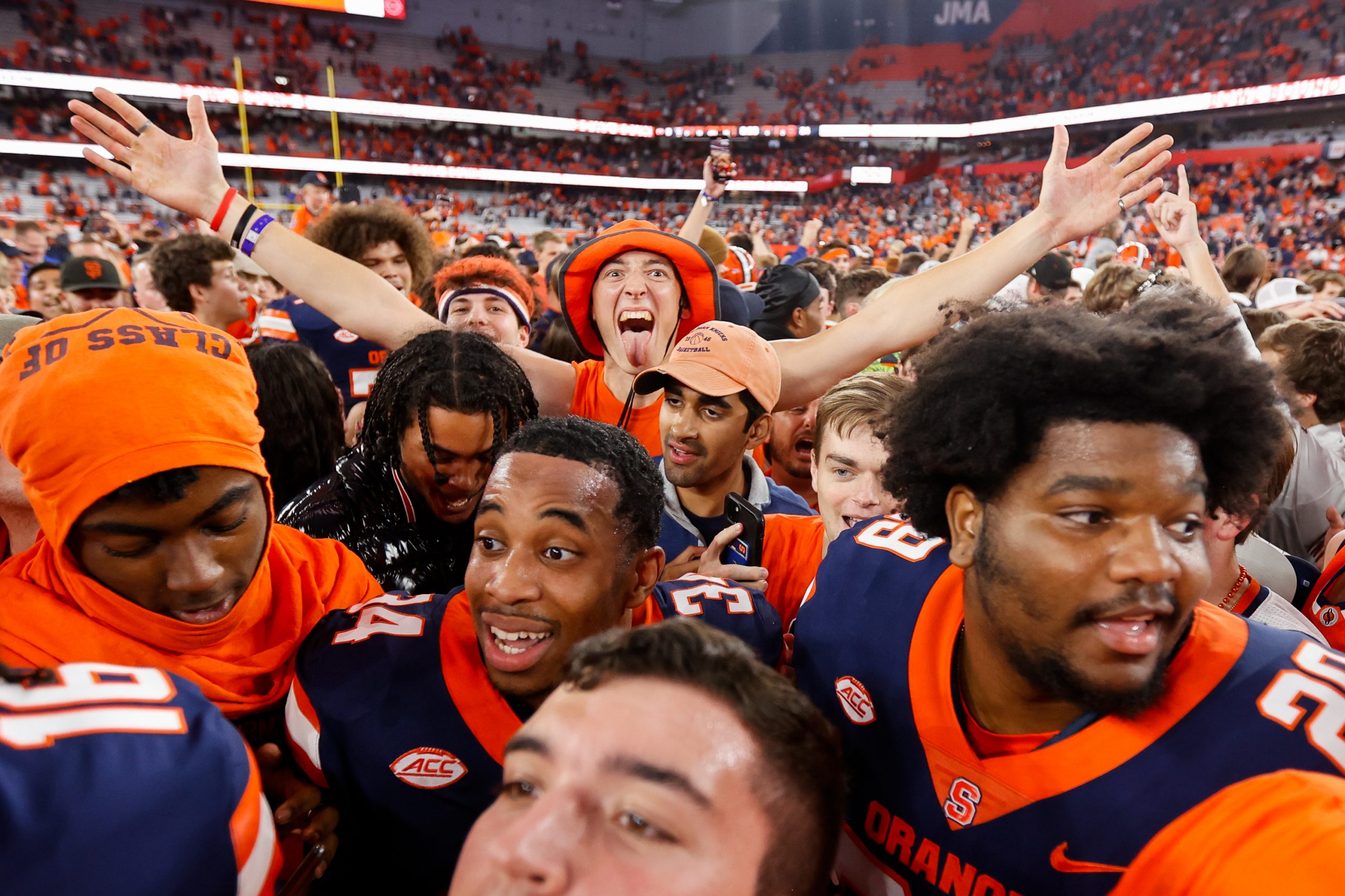 Fans rush the field and celebrate as the #19 Syracuse Orange defeat the #15 NC State Wolfpack 24-9