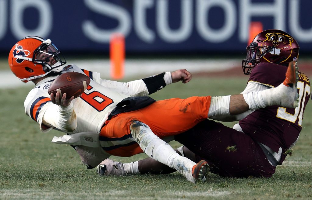 Quarterback Garrett Shrader #6 of the Syracuse Orange is tackled by defensive lineman Darnell Jefferies #90 of the Minnesota Golden Gophers of during the 2nd half of the Bad Boy Mowers Pinstripe Bowl at Yankee Stadium on December 29, 2022 in New York City.
