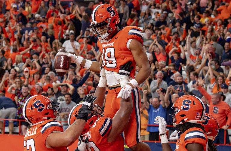 Syracuse players lift team member Oronde Gadsden II up the air after he score the game winning touchdown with eight seconds left in the 4th quarter during a regular season game against Purdue on Saturday, September 17, 2022, at the JMA Wireless Dome.