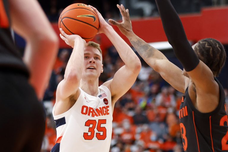Syracuse's Buddy Boeheim lines up a shot from deep between Miami defenders during an ACC men's basketball game on Saturday at the Carrier Dome.