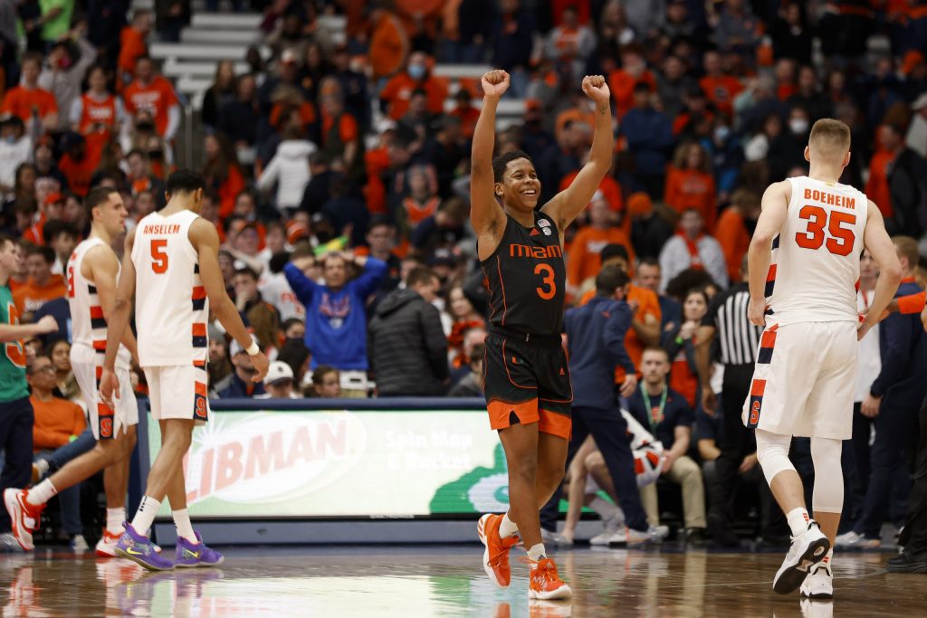 Miami's Charlie Moore (3) raises his hands in the air after the Hurricanes defeated Syracuse 75-72.