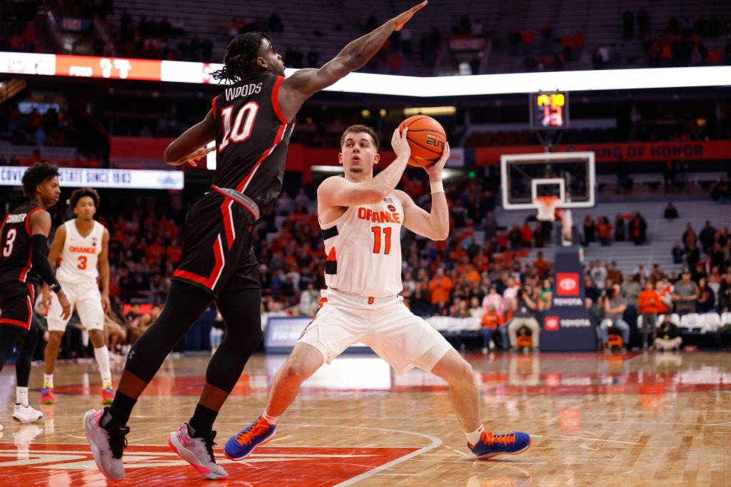 Syracuse's Joseph Girard III (11) gets Northeastern's Harold Woods (10) to bite on a pump fake before making a move for two points.