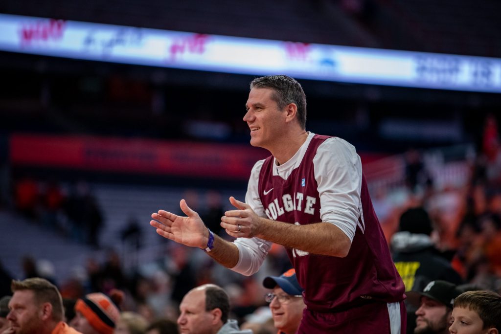 A Colgate super-fan sitting courtside fans in appreciation in his team's win over 'Cuse on November 15, 2022.