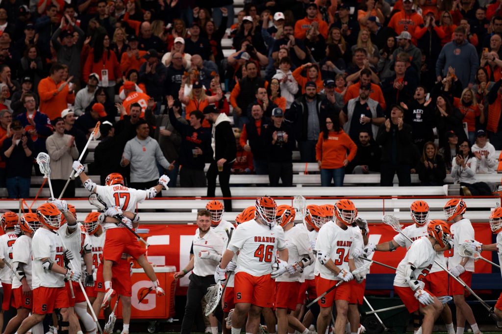 Tommy Drago (17) jumps into fellow SU men's lacrosse players arms celebrating a goal in their team's win over Duke on March 26th, 2022.