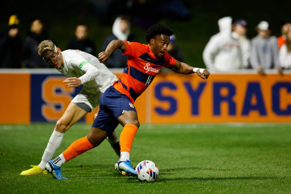 SYRACUSE, NY - NOVEMBER 9: Levonte Johnson #14 of Syracuse Orange moves the ball past Andreas Ueland #17 of Virginia Cavaliers during the ACC Semifinal at SU Soccer Stadium on November 9, 2022 in Syracuse, New York. (Photo by Isaiah Vazquez/The Newshouse)