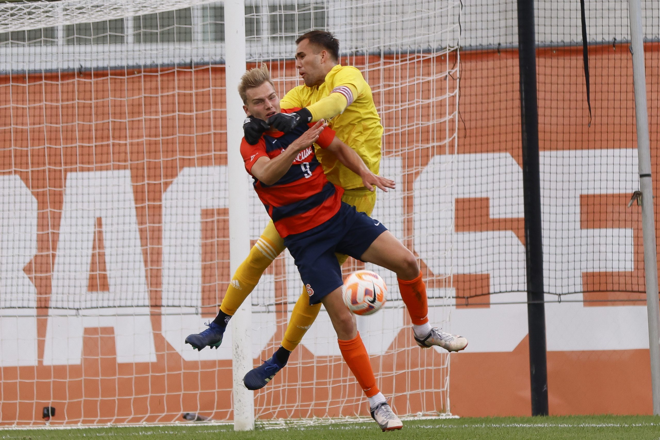 Iona keeper Juan Alfaro Monge (1) tries to knock a ball away from goal as Syracuse's Julius Rauch (9) looks to gain possession and find the back of the net during a non-conference men's soccer game on Thursday at SU Soccer Stadium.