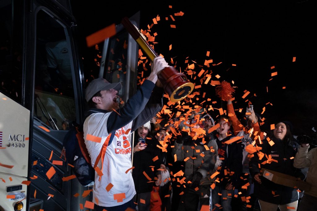 Jeorgio Kocevski #8 of the Syracuse Orange hoists the NCAA trophy during the Men’s Soccer arrival at the John A Lally Athletics Complex on December 13, 2022 in Syracuse, New Yor