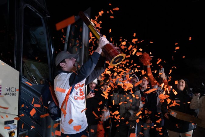 Jeorgio Kocevski #8 of the Syracuse Orange hoists the NCAA trophy during the Men’s Soccer arrival at the John A Lally Athletics Complex on December 13, 2022 in Syracuse, New Yor
