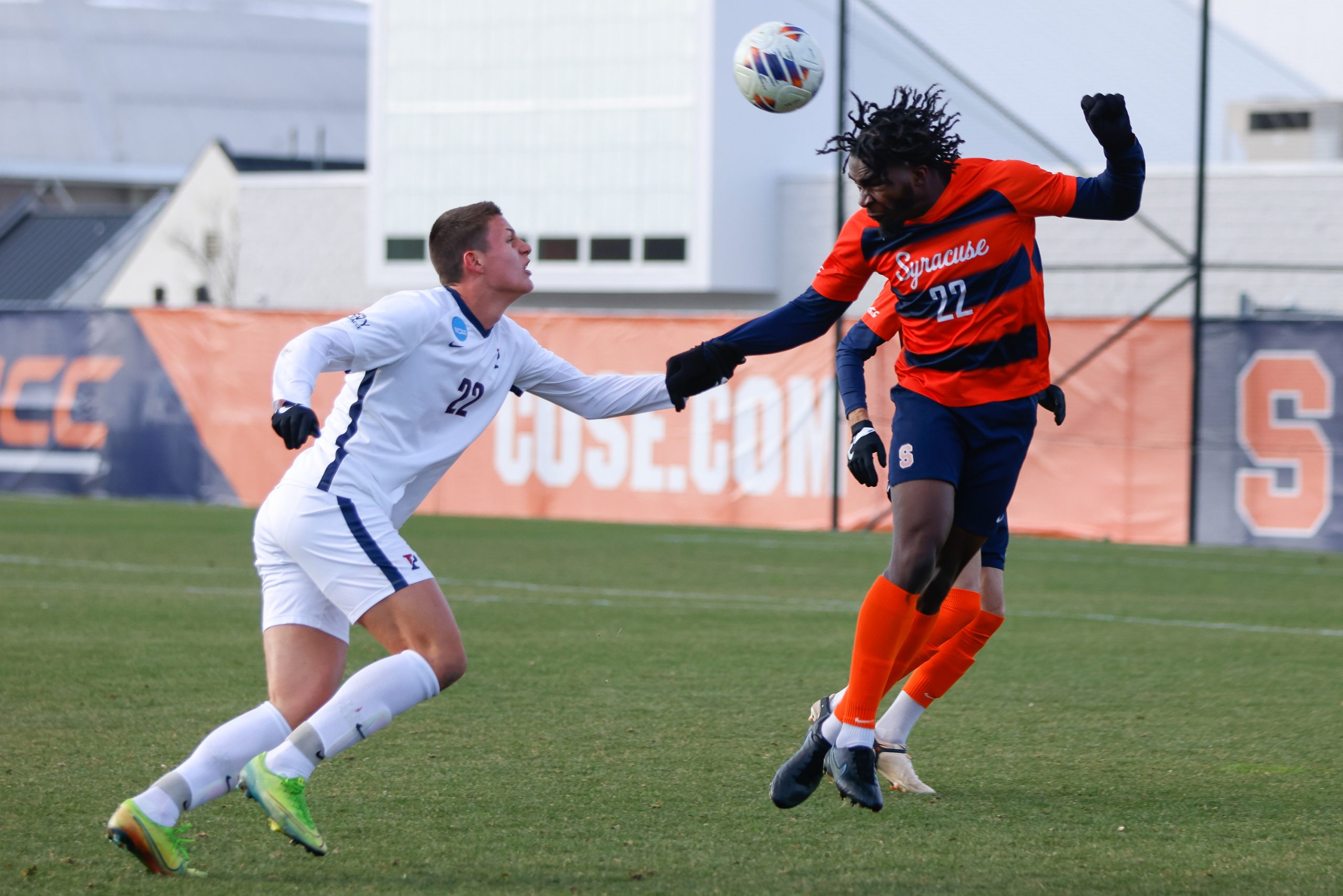 Syracuse's Olu Oyegunle (right) heads a ball forward as Penn's Stas Koreniowski applies pressure during an NCAA Second Round Tournament game on Sunday at SU Soccer Stadium.