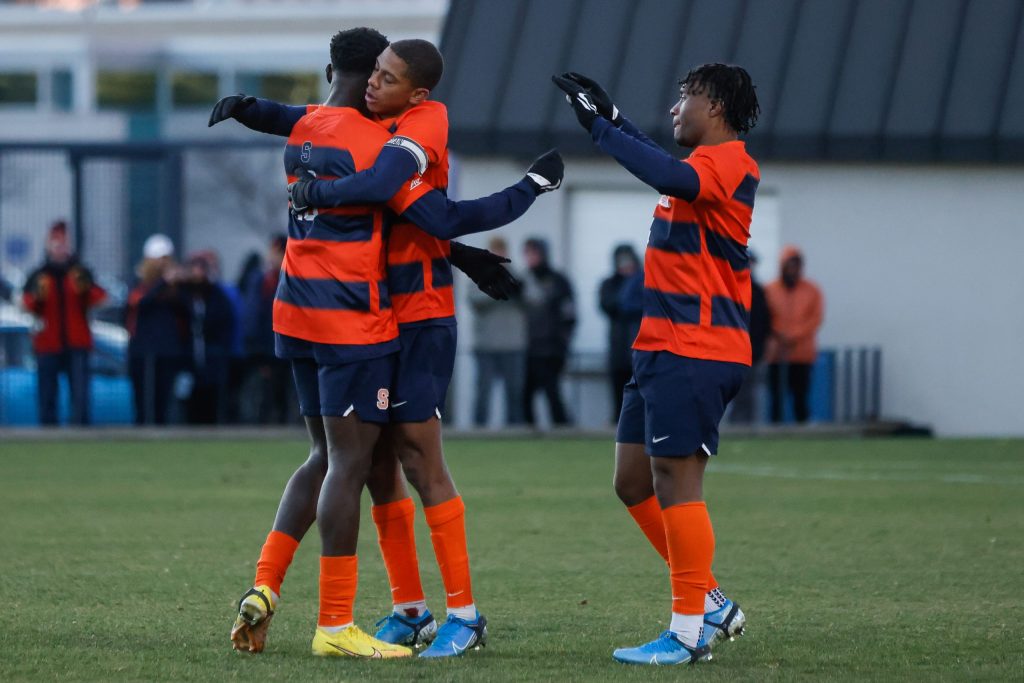 Members of the Syracuse soccer team celebrate after capturing a thrilling 2-1 win over Penn.