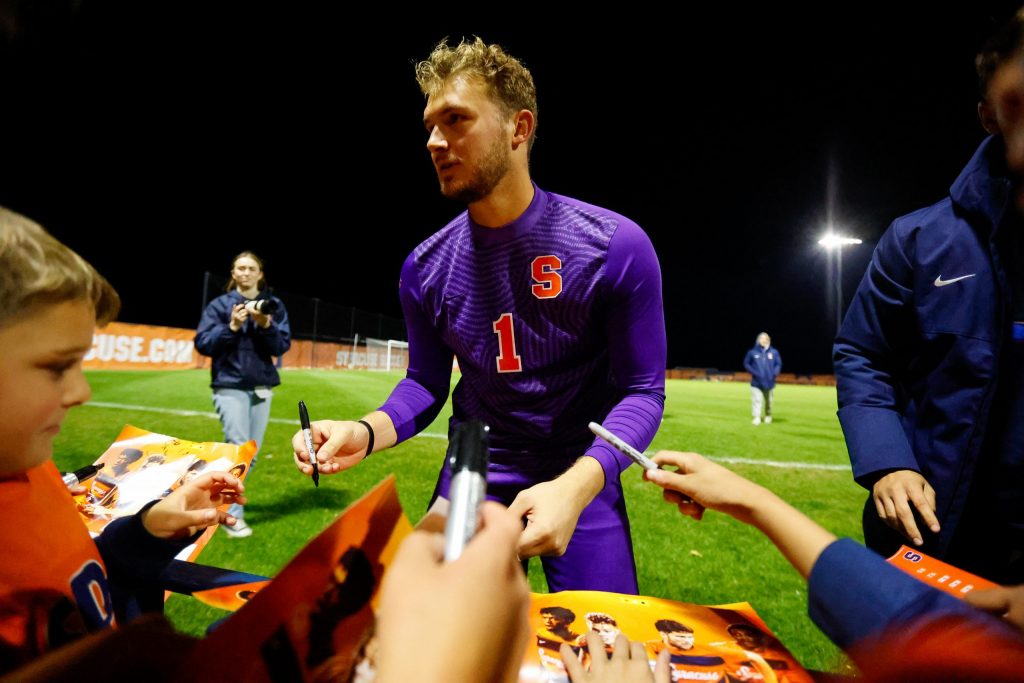 Syracuse goalie Russell Shealy (1) signs autographs for fans after the win.