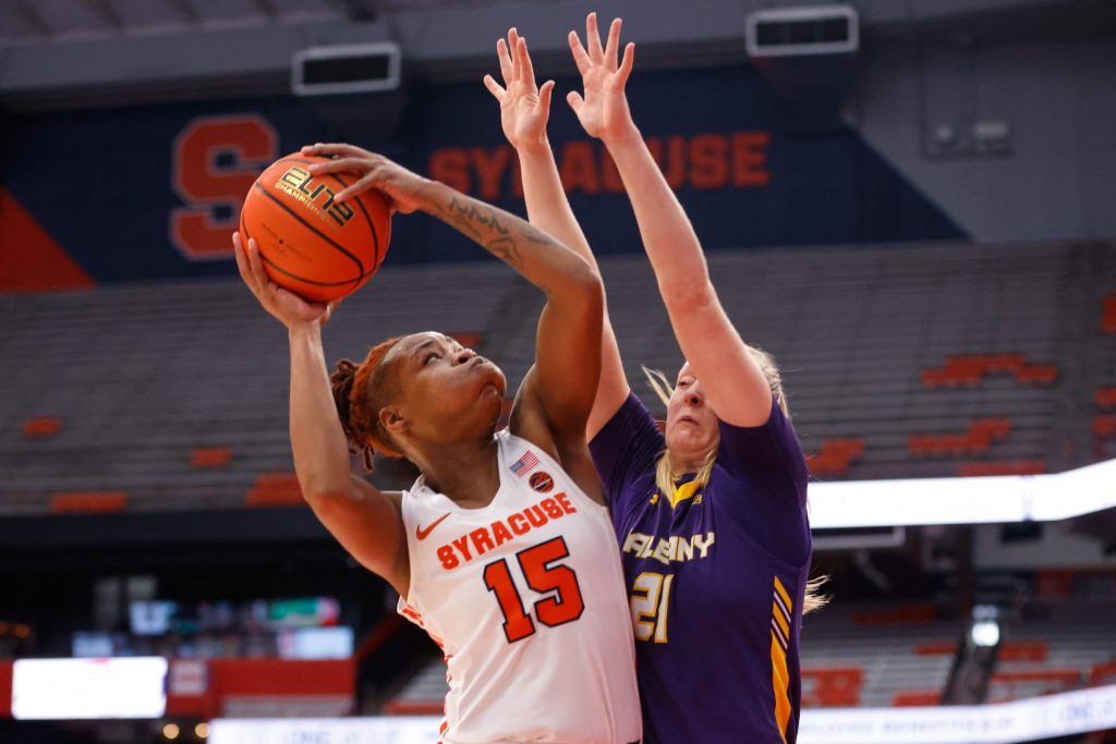 Syracuse's Asia Strong (15) eyes the basket as Albany's Helene Haegerstrand (21) attemtps to block the shot during a women's basketball game on Tuesday, December 20, 2022, at JMA Wireless Dome.