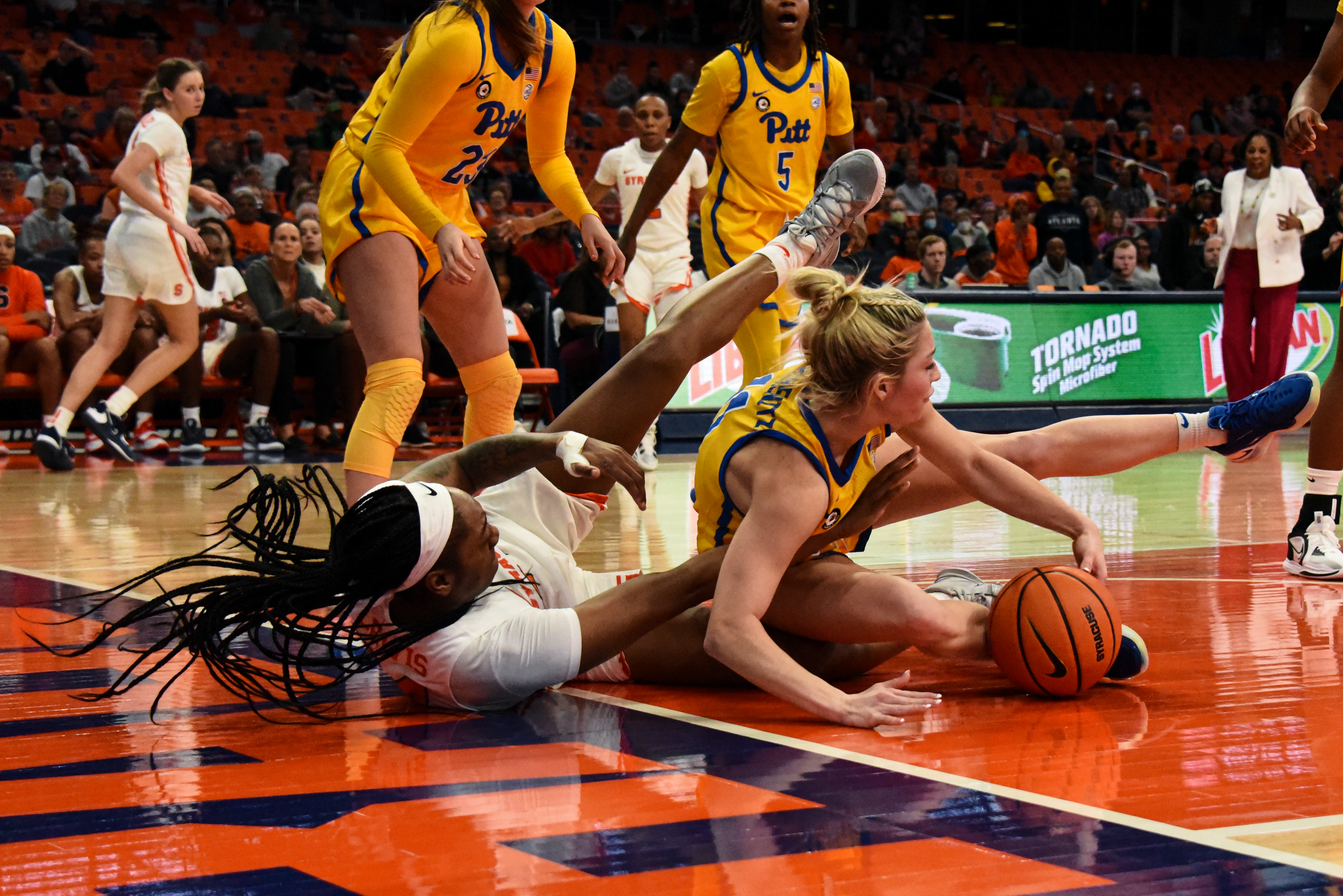 Syracuse forward Dariauna Lewis falls with a Pitt player during the Orange's win Wednesday at the JMA Wireless Dome.