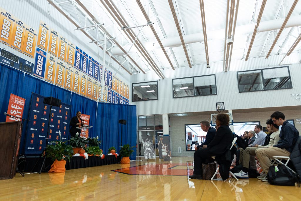 A wide shot of Felisha Legette-Jack at the podium during the official press conference in the Melo Center on March 28th, 2022.