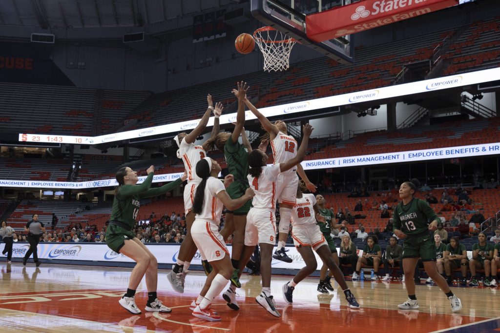 Syracuse's Cheyenne Evans (12) rises over a group of Syracuse and Wagner players in SU's win on December 11, 2022.