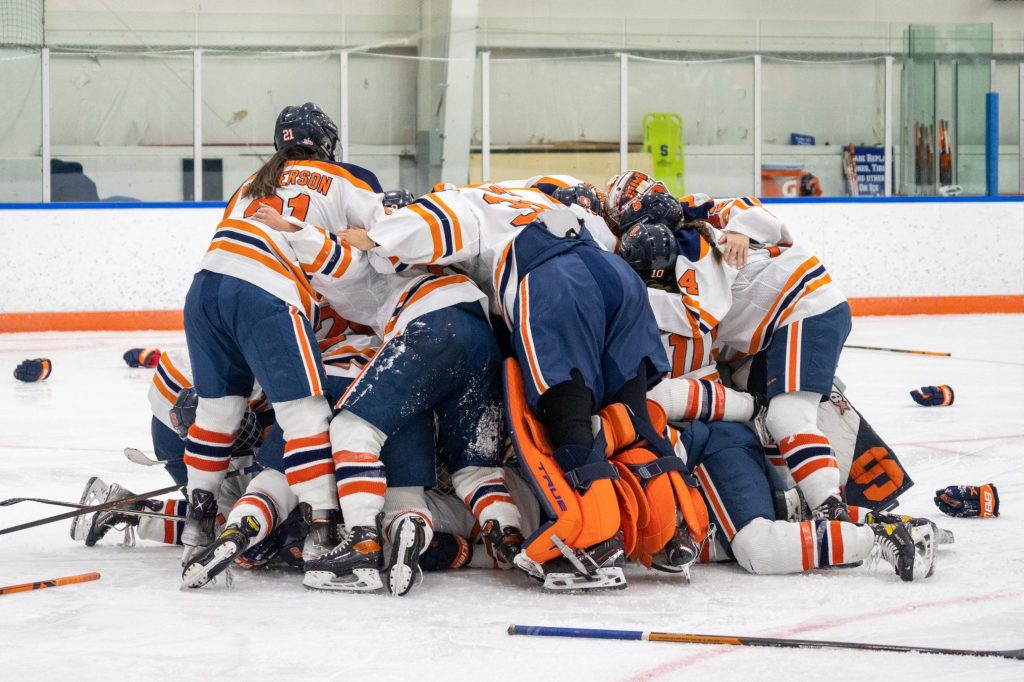 The Syracuse women's hockey team piles on top of Sarah Thompson after she scored the game-winning goal.
