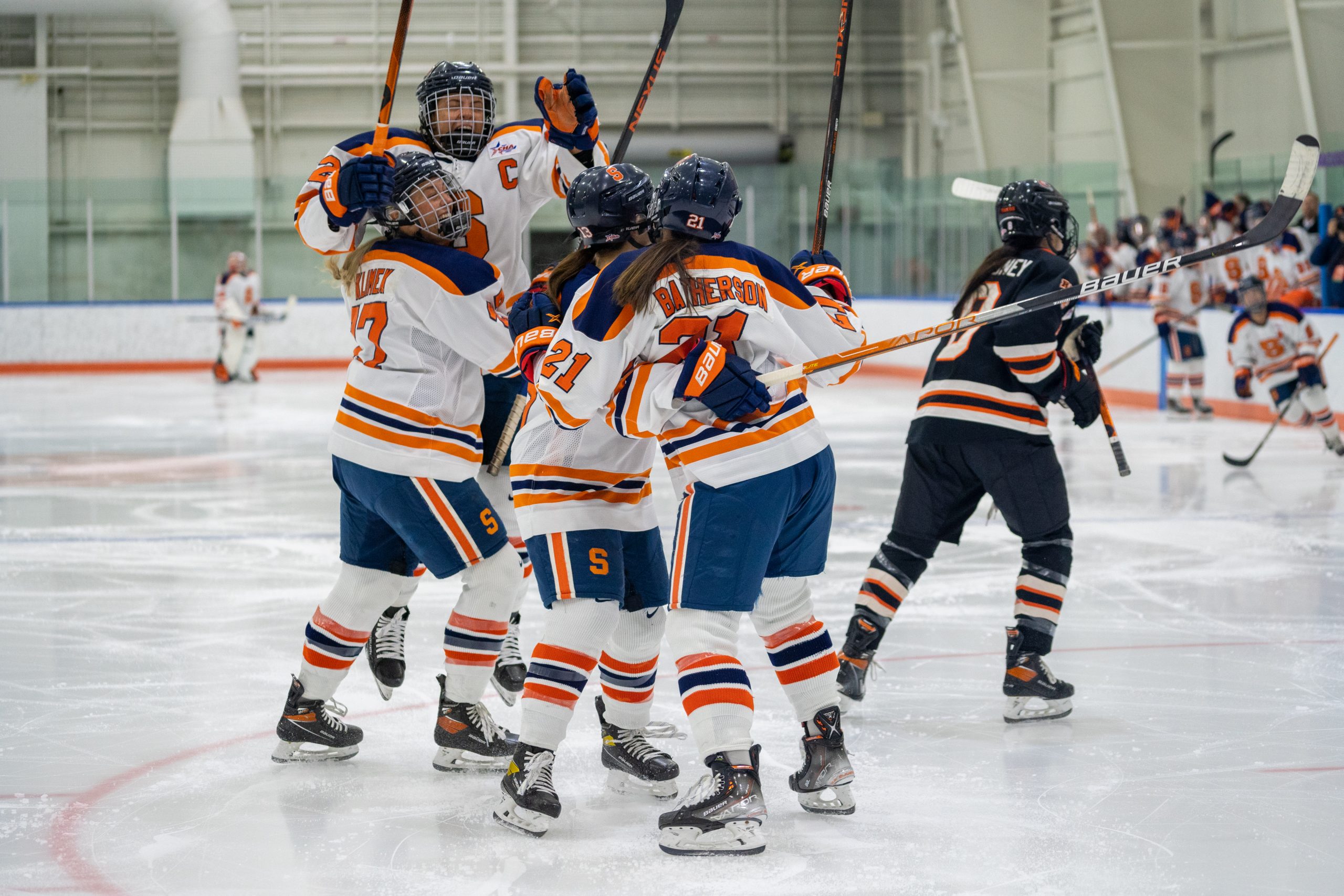 The Syracuse women's hockey team celebrates after winning in overtime against RIT during the CHA hockey semifinals Friday at Tennity Ice Pavilion.