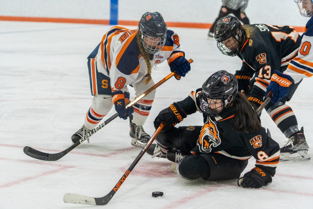 Syracuse's Lauren Bellefontaine (8) lunges for the puck with RIT's Lindsay Maloney attempts to get gain possession