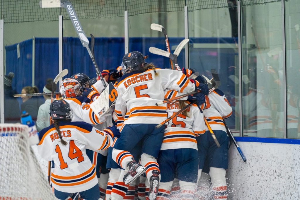The Syracuse women's hockey team piles on top of Abby Moloughney after she scored the winning goal in overtime.