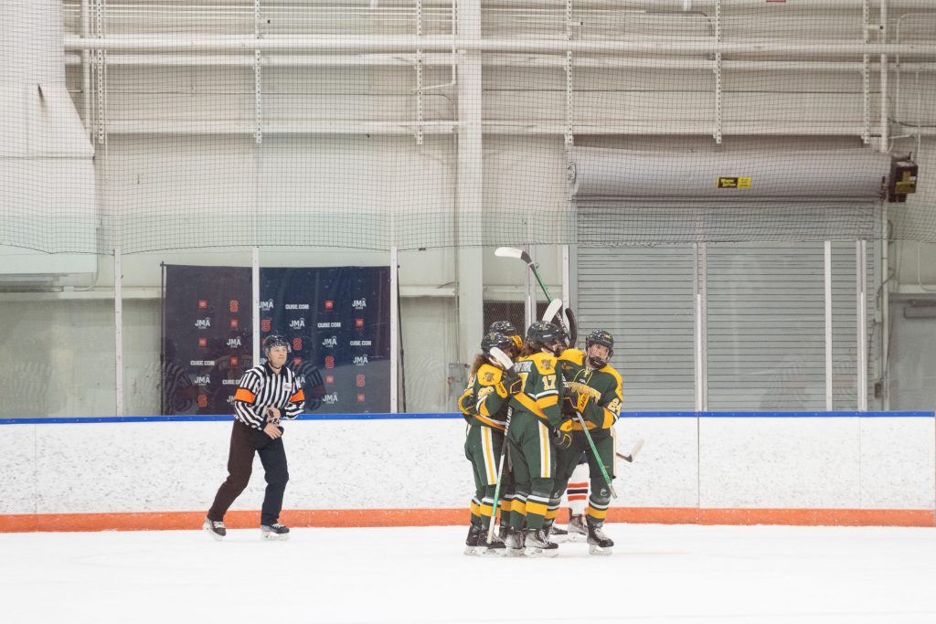 UVM players celebrate their win of the women's Ice Hockey game on Friday, December 9, 2022 at Tennity Ice Pavilion in Syracuse, NY.