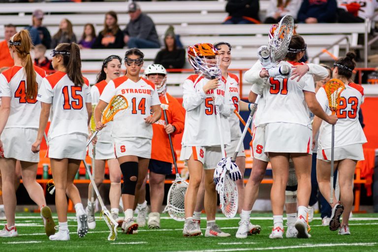 Emily Hawryschuk (51) and teammates celebrate her school-record-setting goal against UAlbany during the Women's Lacrosse game in the Dome at Syracuse University at Syracuse, New York on April 19, 2022.