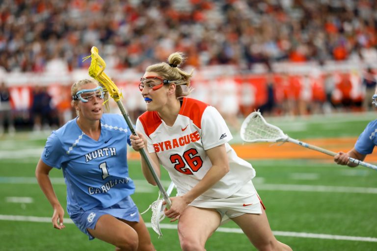 Sarah Cooper (26) battles against UNC player during Syracuse vs. North Carolina women's lacrosse game on April 9, 2022, in the Carrier Dome.