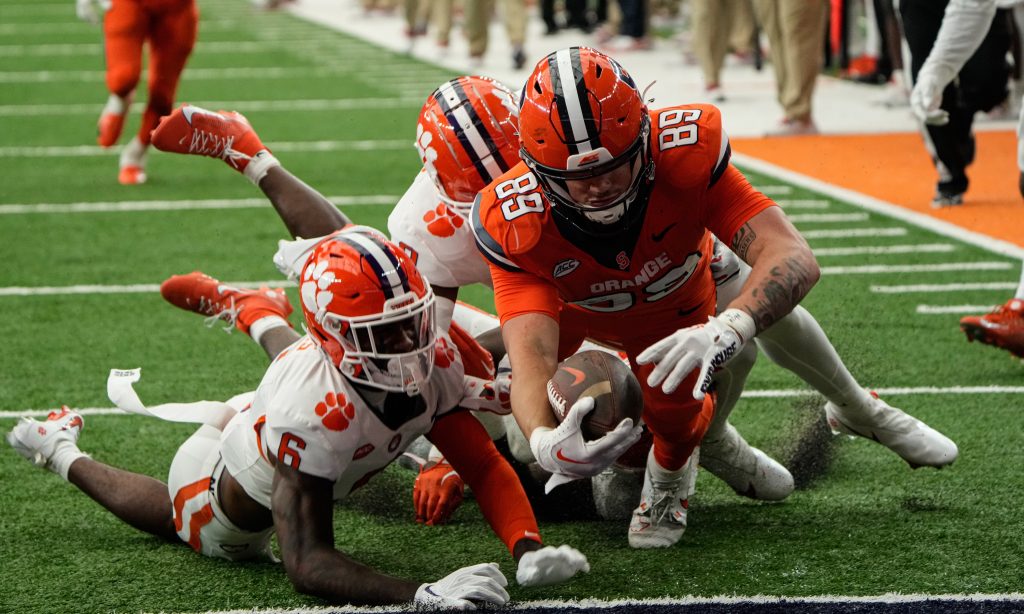 Syracuseâs Dan Villari holds his arm out to get the ball into teh end zone for a touch down at the football across the at the football game against Clemson in Syracuse, N.Y., Saturday, Sept. 30, 2023.