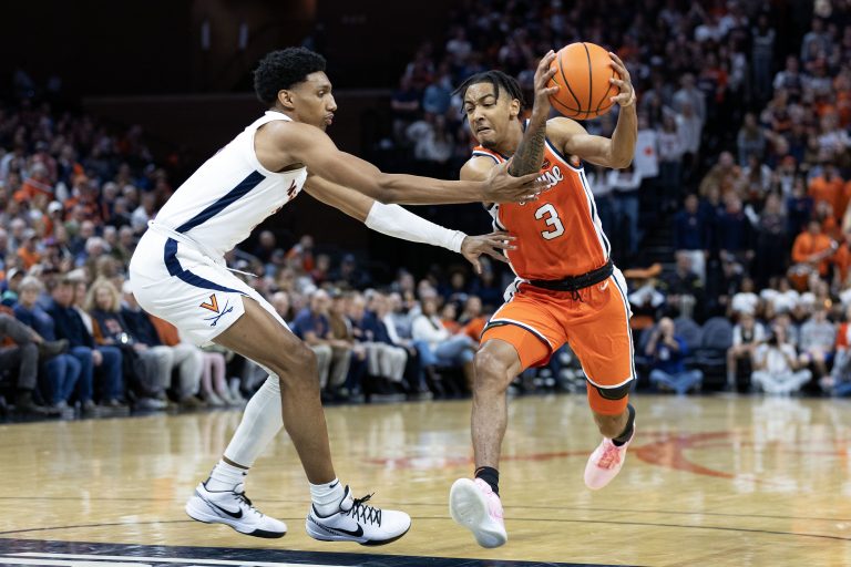 Judah Mintz #3 of the Syracuse Orange drives past Ryan Dunn #13 of the Virginia Cavaliers in the first half during a game at John Paul Jones Arena on December 2, 2023 in Charlottesville, Virginia.