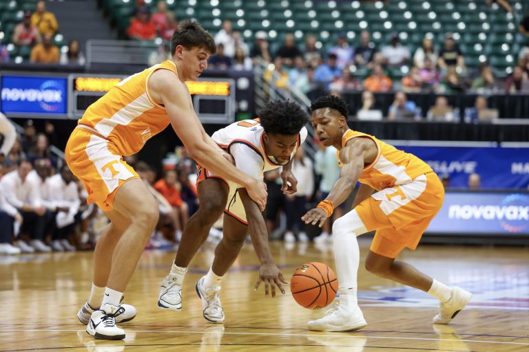 Naheem McLeod #10 of the Syracuse Orange dribbles past J.P. Estrella #13 (L) and Jordan Gainey #2 of the Tennessee Volunteers during the first half of the game at SimpliFi Arena on November 20, 2023 in Honolulu, Hawaii.