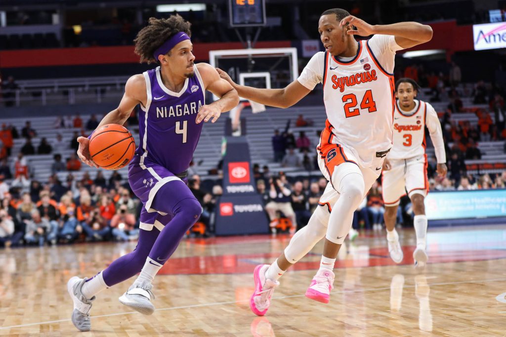 Niagara's Braxton Bayless (#4) attempts a run past Syracuse's Quadir Copeland (#24) during the non-conference game on Thursday.