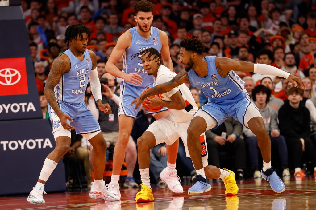 Syracuse's Judah Mintz (center) attempts to hold the ball away from North Carolina defenders during an ACC men's basketball game on Tuesday, January 25, 2022, at JMA Wireless Dome.