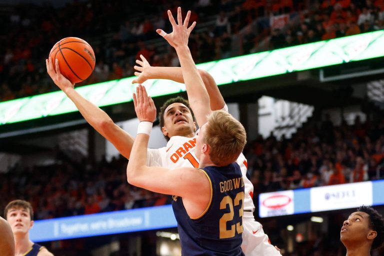 Syracuse's Jesse Edwards leans for a shot as Notre Dame's Dane Goodwin jumps to block during an ACC basketball game Saturday at JMA Wireless Dome.