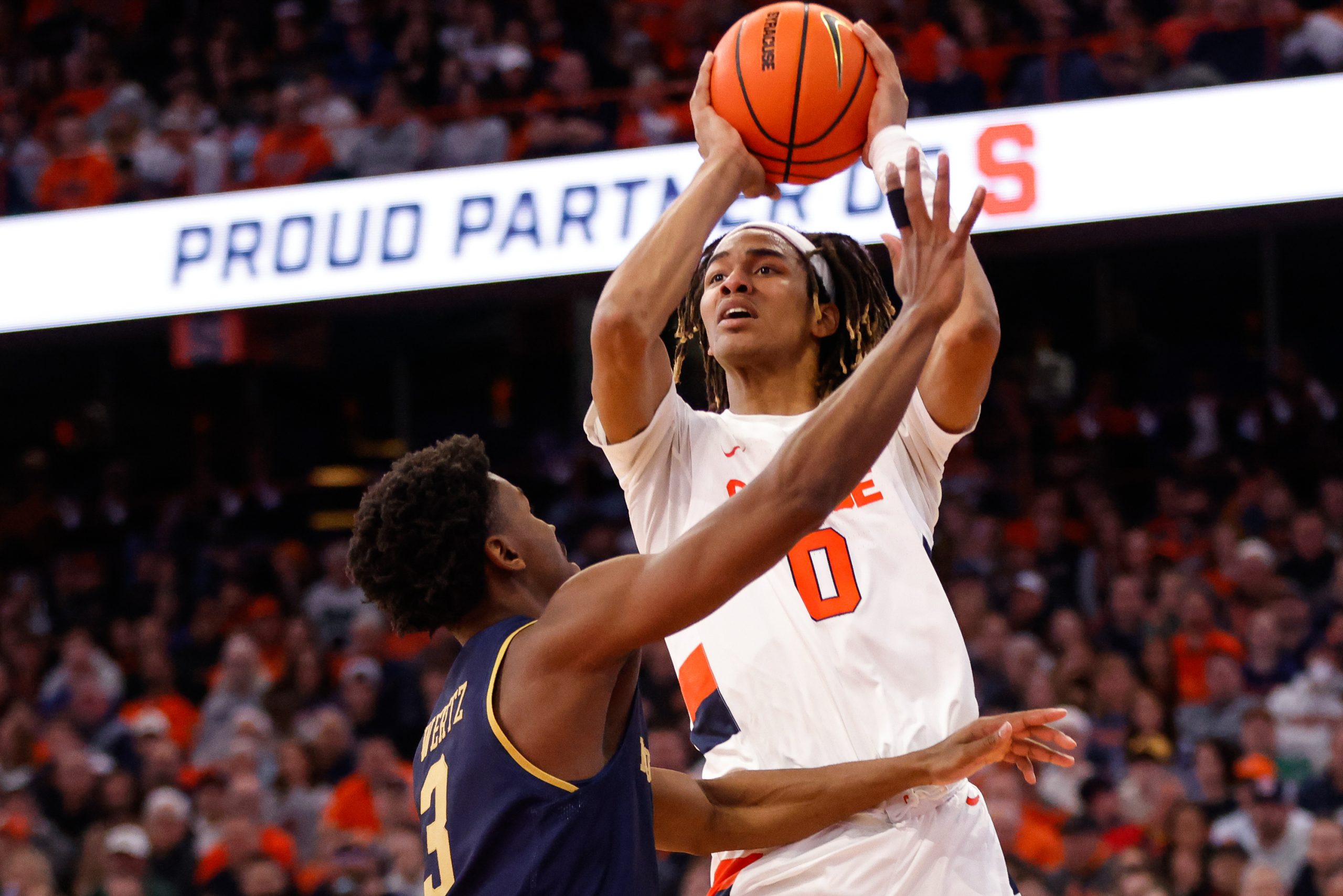 Syracuse's Chris Bell (0) attempts a shot as Notre Dame's Trey Wertz (3) tries to block during an ACC basketball game Saturday at JMA Wireless Dome.