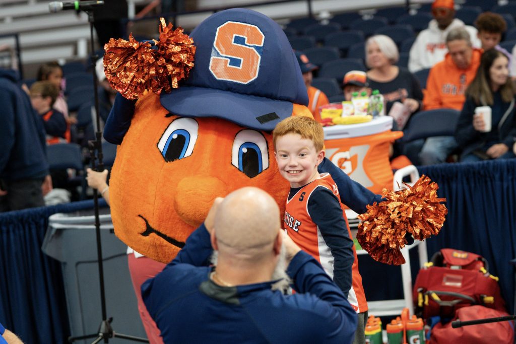 Otto takes pictures with a young Syracuse basketball fan during the Orange Tipoff event at the JMA Wireless Dome on Oct. 13, 2023.