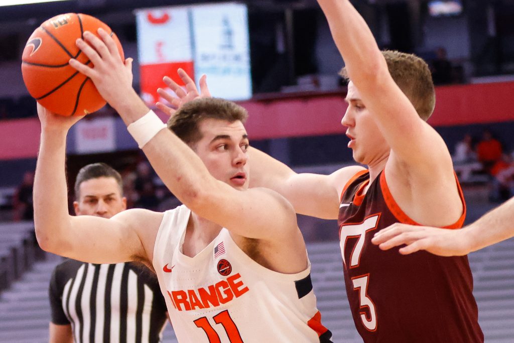 Syracuse's Joseph Girard III (11) looks to pass the ball as Virginia Tech's Sean Pedulla (3) defends during an ACC basketball game Wednesday at JMA Wireless Dome.