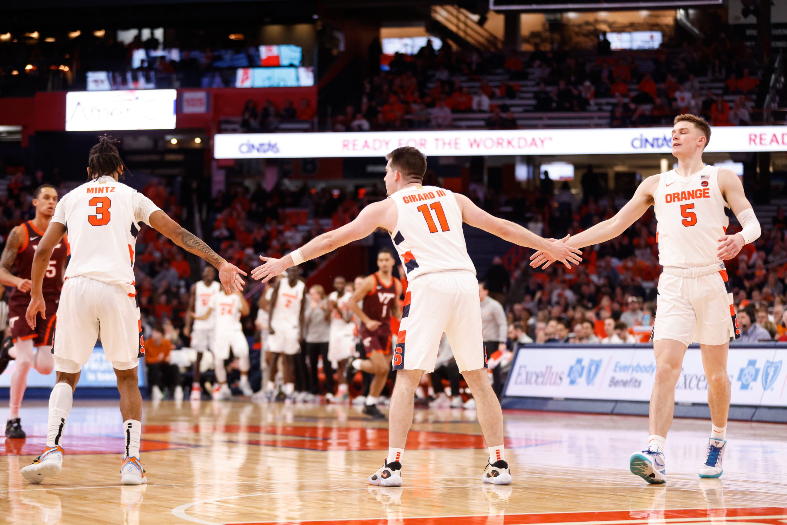 Syracuse's Joseph Girard III (11) high-fives teammates Judah Mintz (3) and Justin Taylor (5) after a three-pointer during an ACC basketball game against Virginia Tech Wednesday at JMA Wireless Dome.