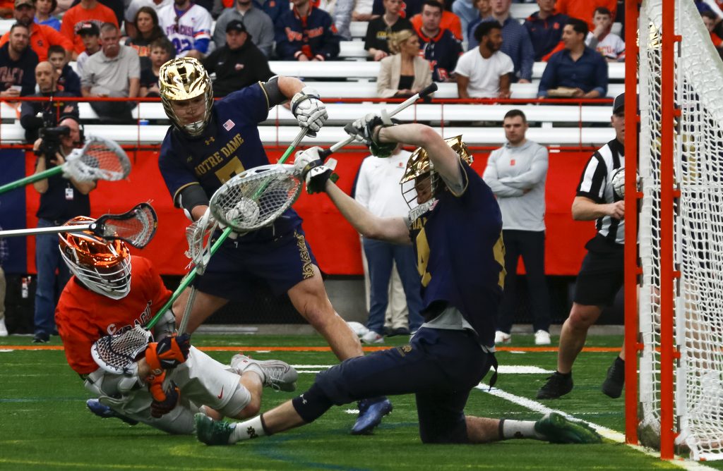 SU attack Kirst dives to score a goal against Notre Dame.