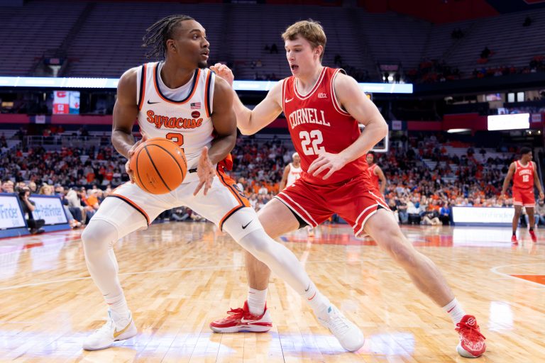 Syracuse's J.J. Starling (#2) looks for an open teammate as Cornell's Jake Fiegen (#22) guards during a non-conference game on Tuesday, December 5 at the JMA Wireless Dome.