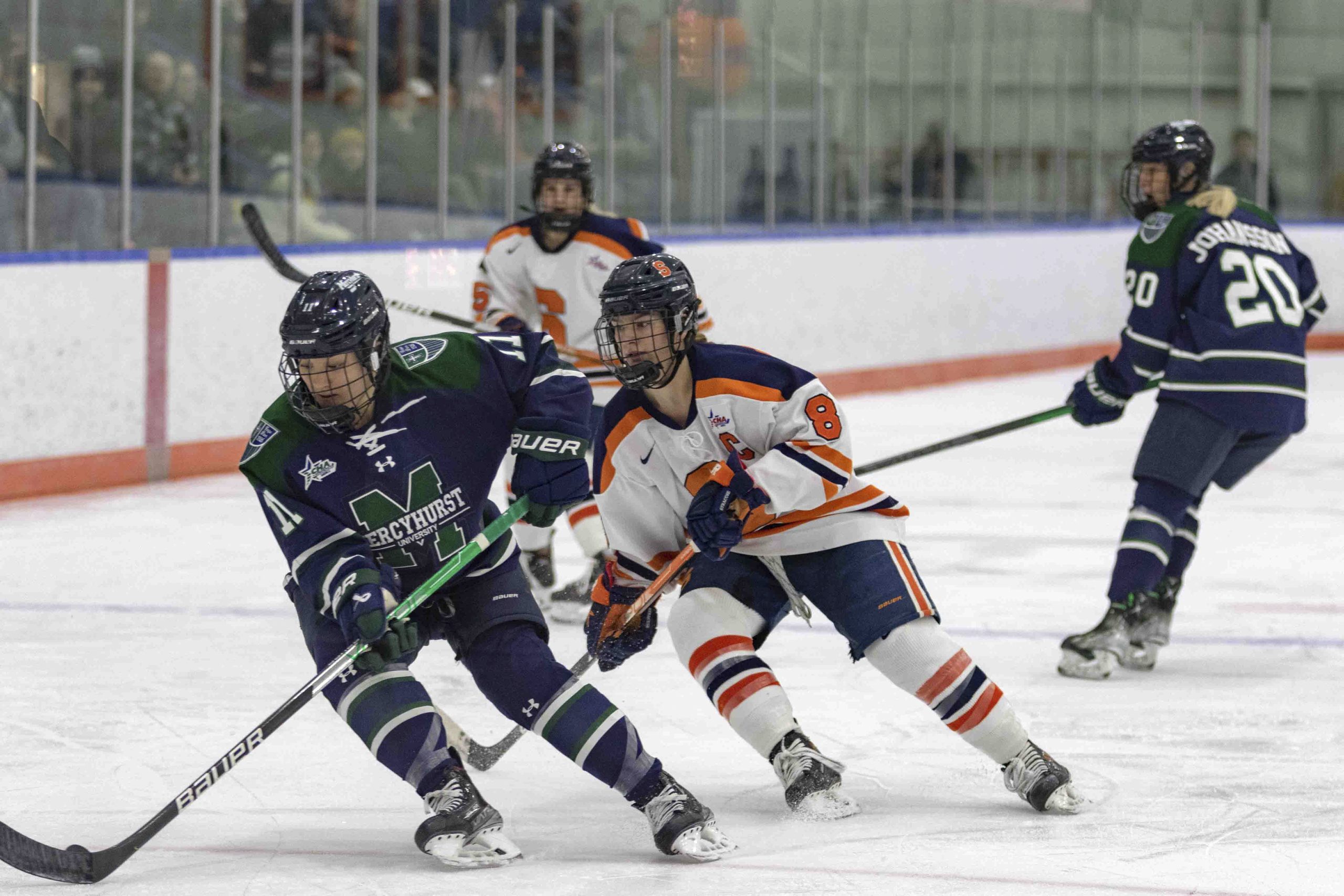 SU player, Lauren Bellefontaine (8) and Mercyhurst Makayla Javier (11) battling for possesion at Tennity ice rink.