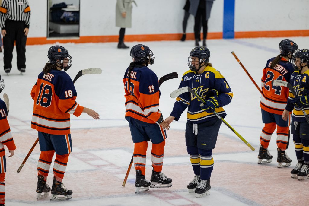 Syracuse and Merrimack players shake hands after a Merrimack victory of 4 - 0 on Saturday.
