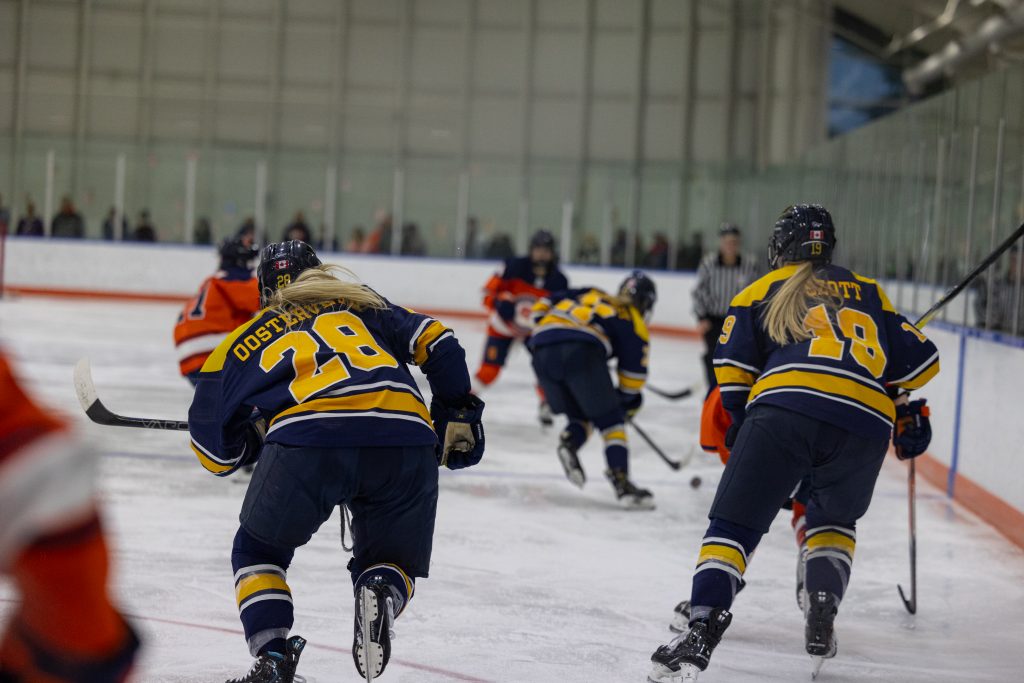 Merrimack Forwards Emily Oosterveld (#28) and Raice Szott (#19) race down the ice on a fast break at Saturday's game.