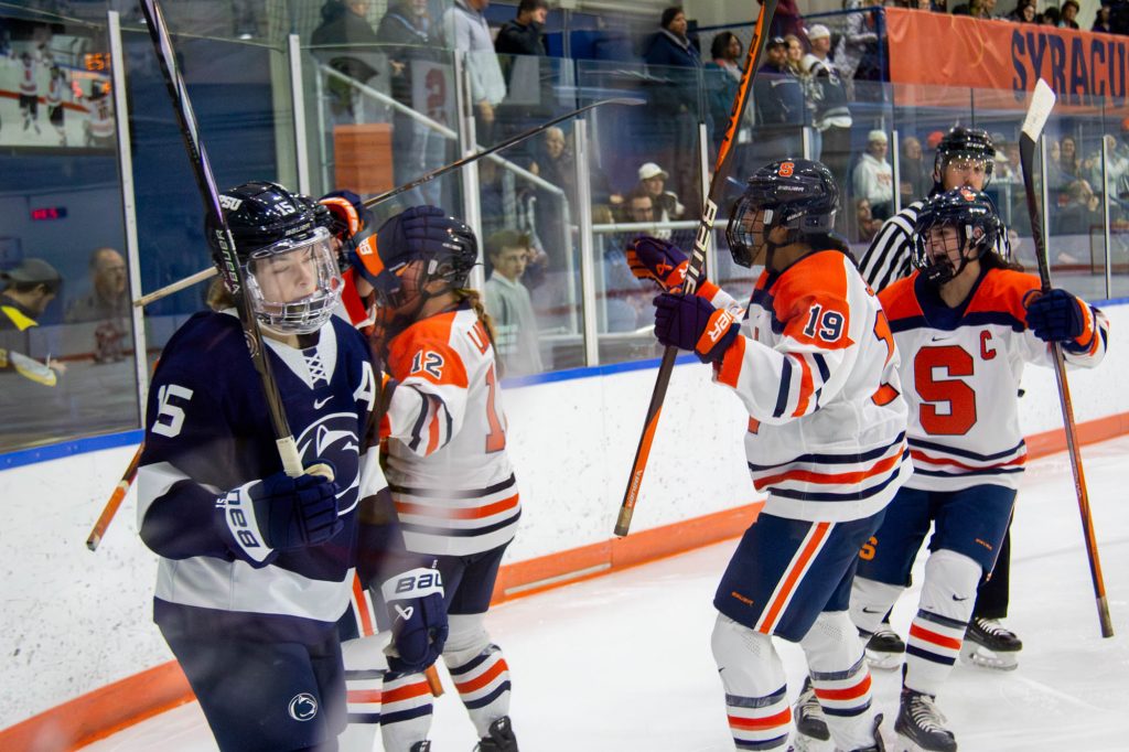 SU teammates celebrate after their first goal of Saturday night's game.