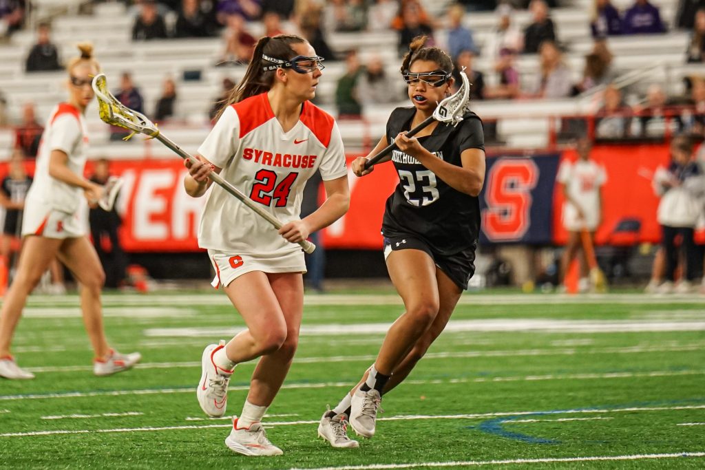 Emma Tyrrell (#24) scores 3 goals for Syracuse, beating NU in a close, 16-15 game.